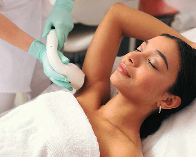 Aesthetician treating a patient for laser hair removal