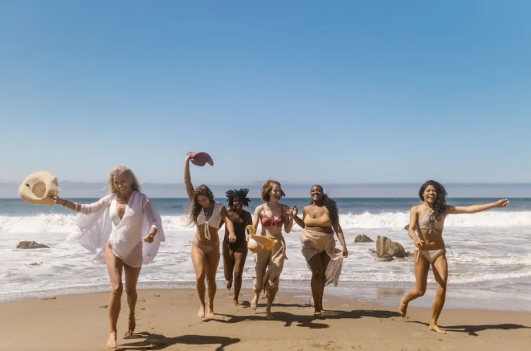 women on the beach having fun